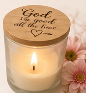 Lit personalised candle with a wooden message lid