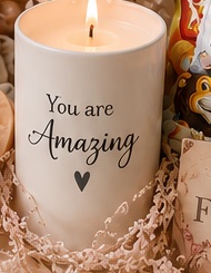 Lit personalised candle with an uplifting message